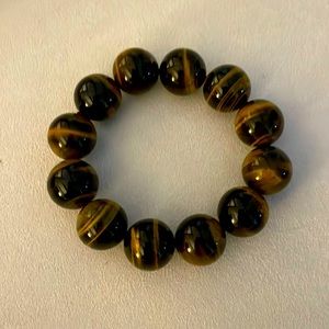 A tiger’s eye bracelet made with 2” beads- 6” diameter with elastic stretch